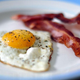 Close-up of eggs and bacon on plate